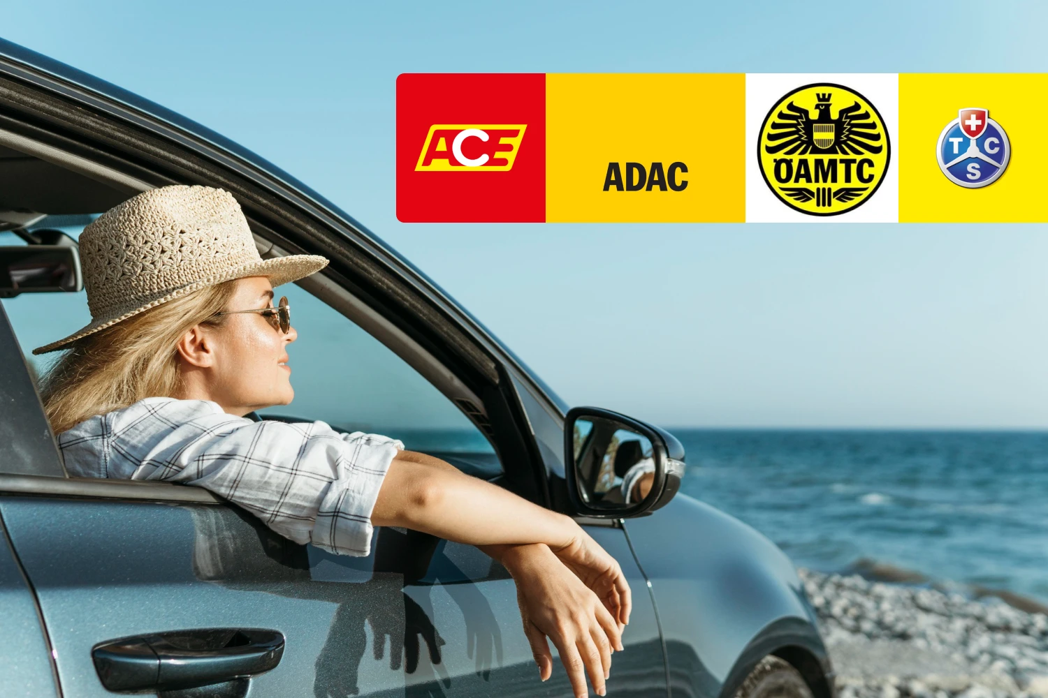 A woman is a passenger in a car parked on the coast. The logos of well-known automobile clubs appear at the top right of the image.