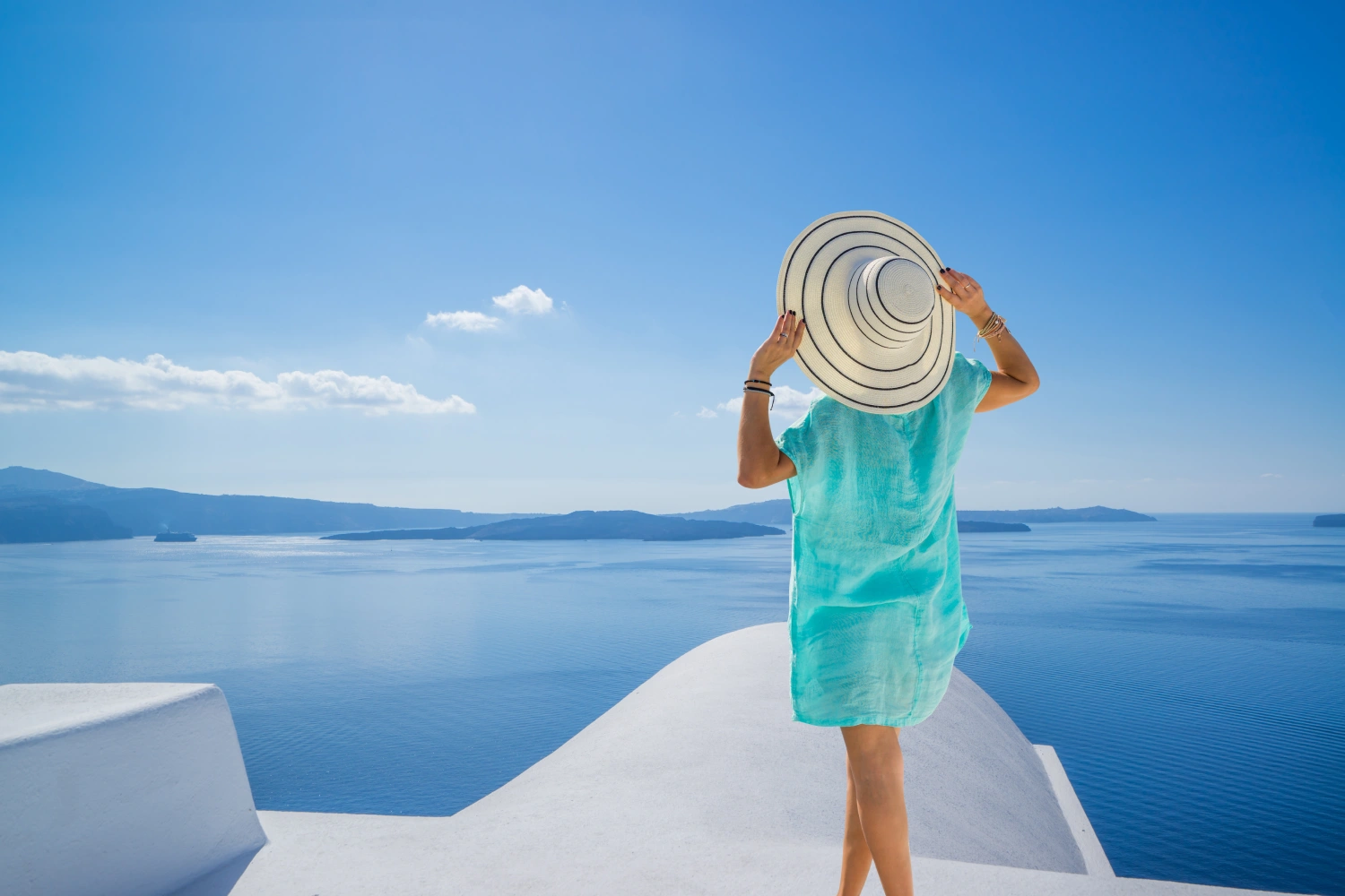 Woman on terrace overlooking the caldera in Santorini, Greece