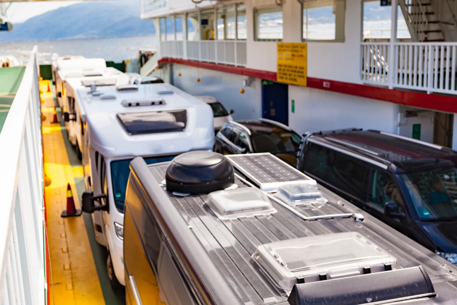 Campers and cars on the open garage deck of the ferry in Europe.